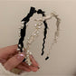 Close-up of Gifty Sweet Oval Bead Bow Headband showing oval beads and bow detail