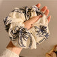 Close-up of coconut tree design on vintage print scrunchie
