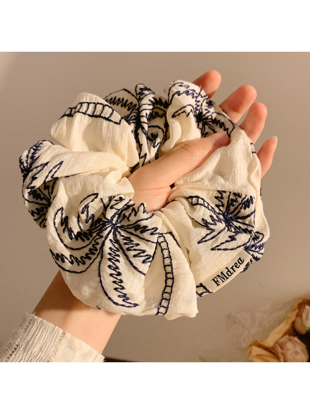 Close-up of coconut tree design on vintage print scrunchie