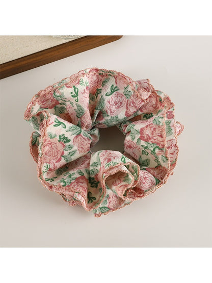 Gifty scrunchie worn in a ponytail with visible pink and white floral pattern