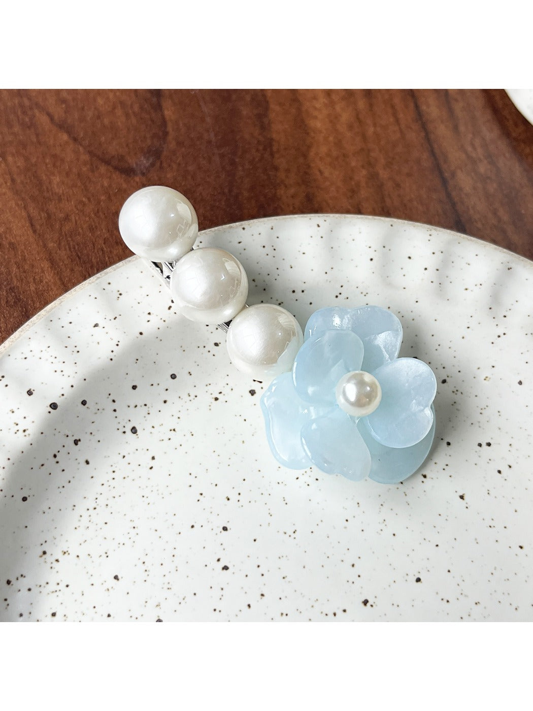 Beau Camellia shaped hair clip photographed with natural lighting