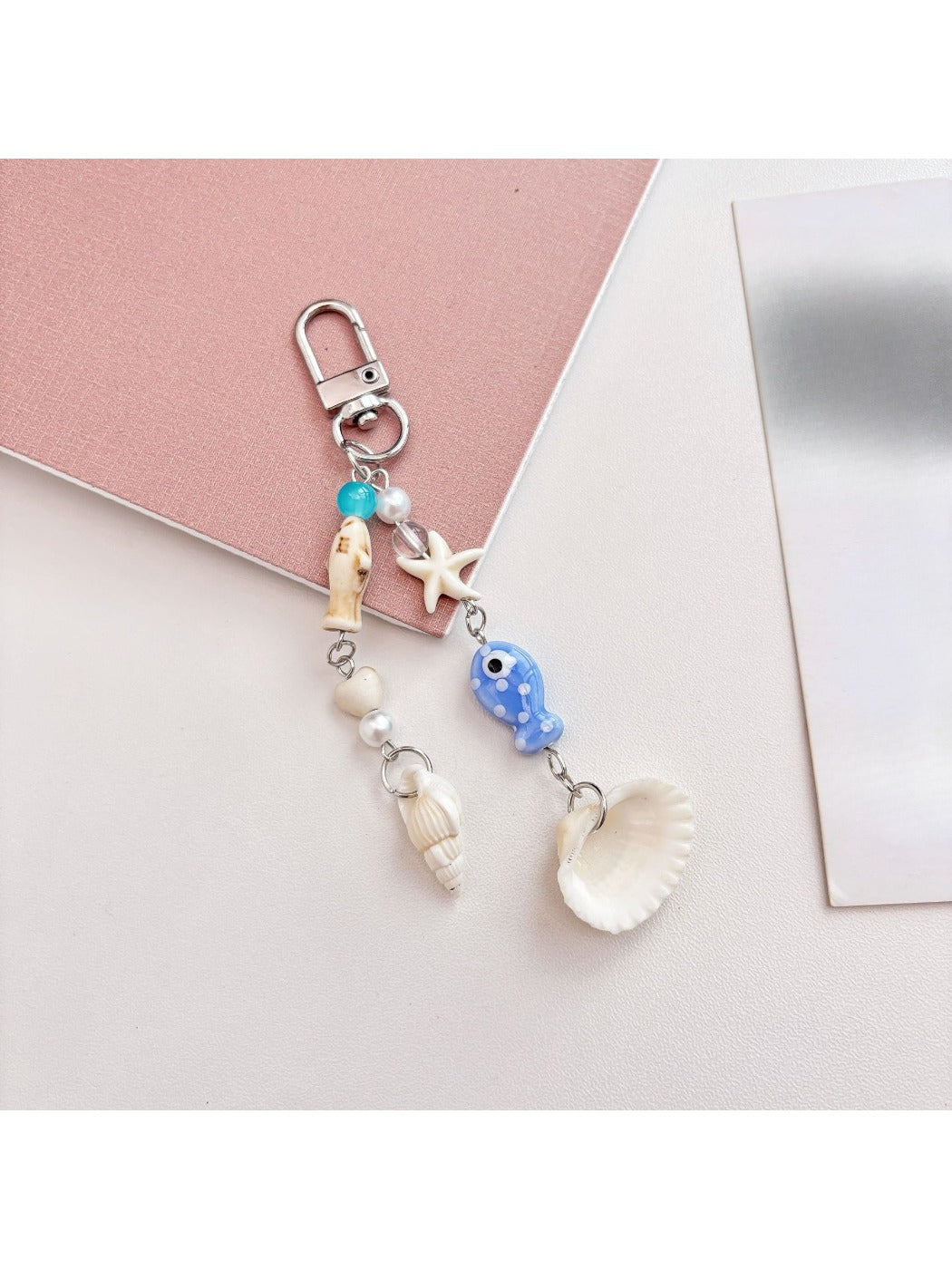 Blue fish keychain held in hand displaying size and shape