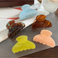 Close-up of Beau Sweet Chic acetate claw clip showing curved teeth and glossy finish