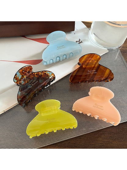 Close-up of Beau Sweet Chic acetate claw clip showing curved teeth and glossy finish