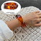 Lovra ombre bangle bracelet resting on textured surface with soft lighting