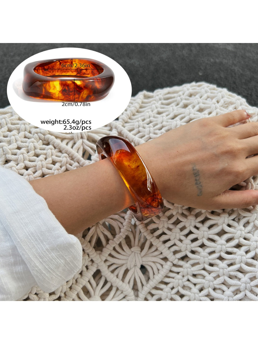 Lovra ombre bangle bracelet resting on textured surface with soft lighting