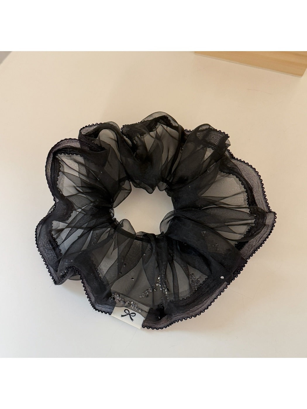 Gifty scrunchie stretched slightly to show elasticity and fabric quality