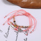 Lovra small bead bracelet styled with other jewelry pieces on a model's wrist