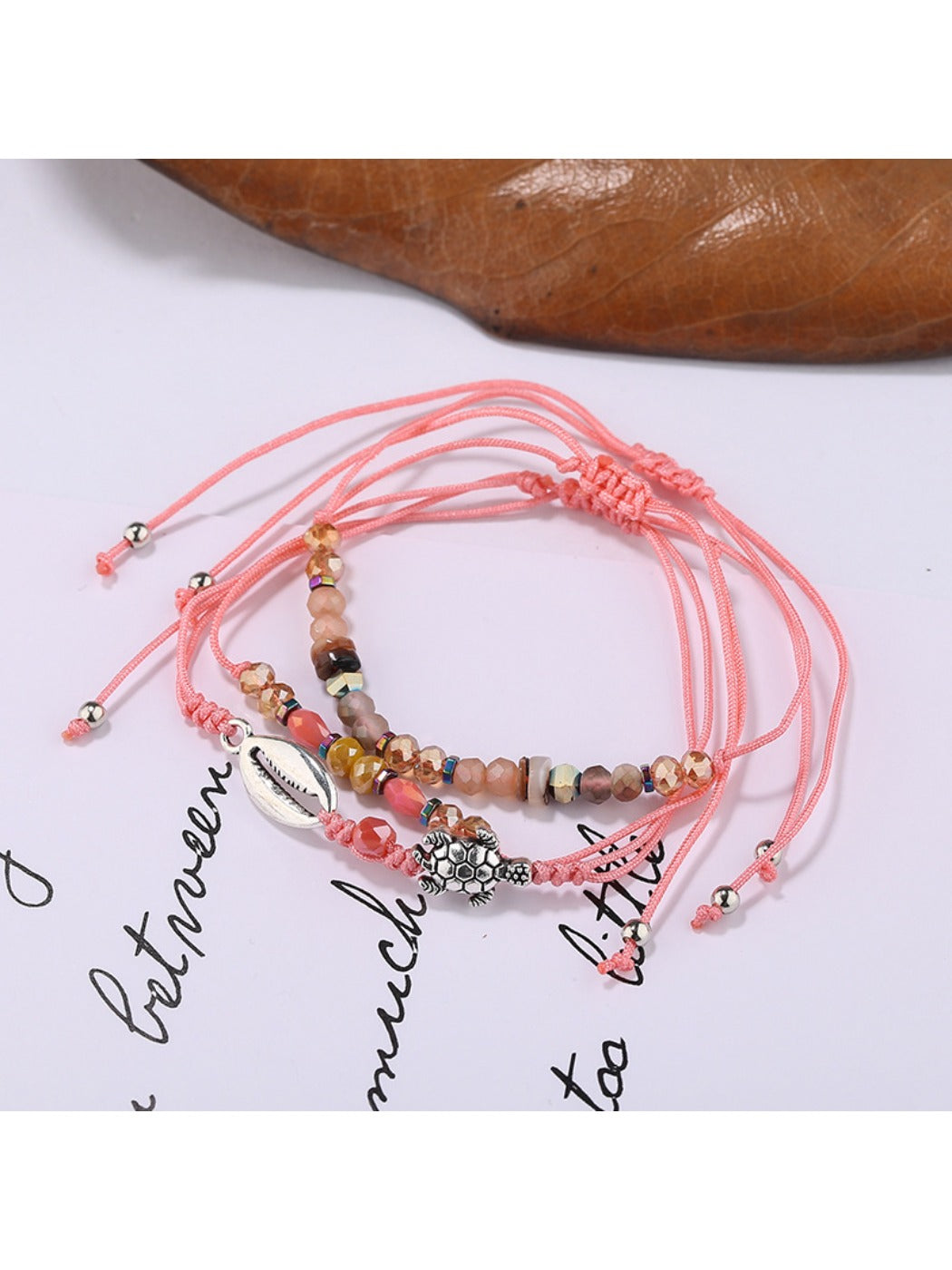 Lovra small bead bracelet styled with other jewelry pieces on a model's wrist