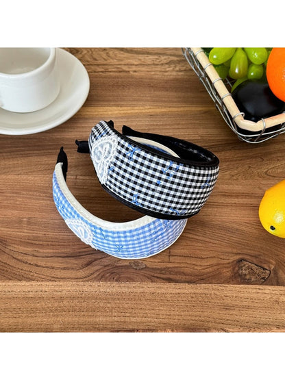 Close-up of Gifty plaid bow print headband showing fabric texture and pattern