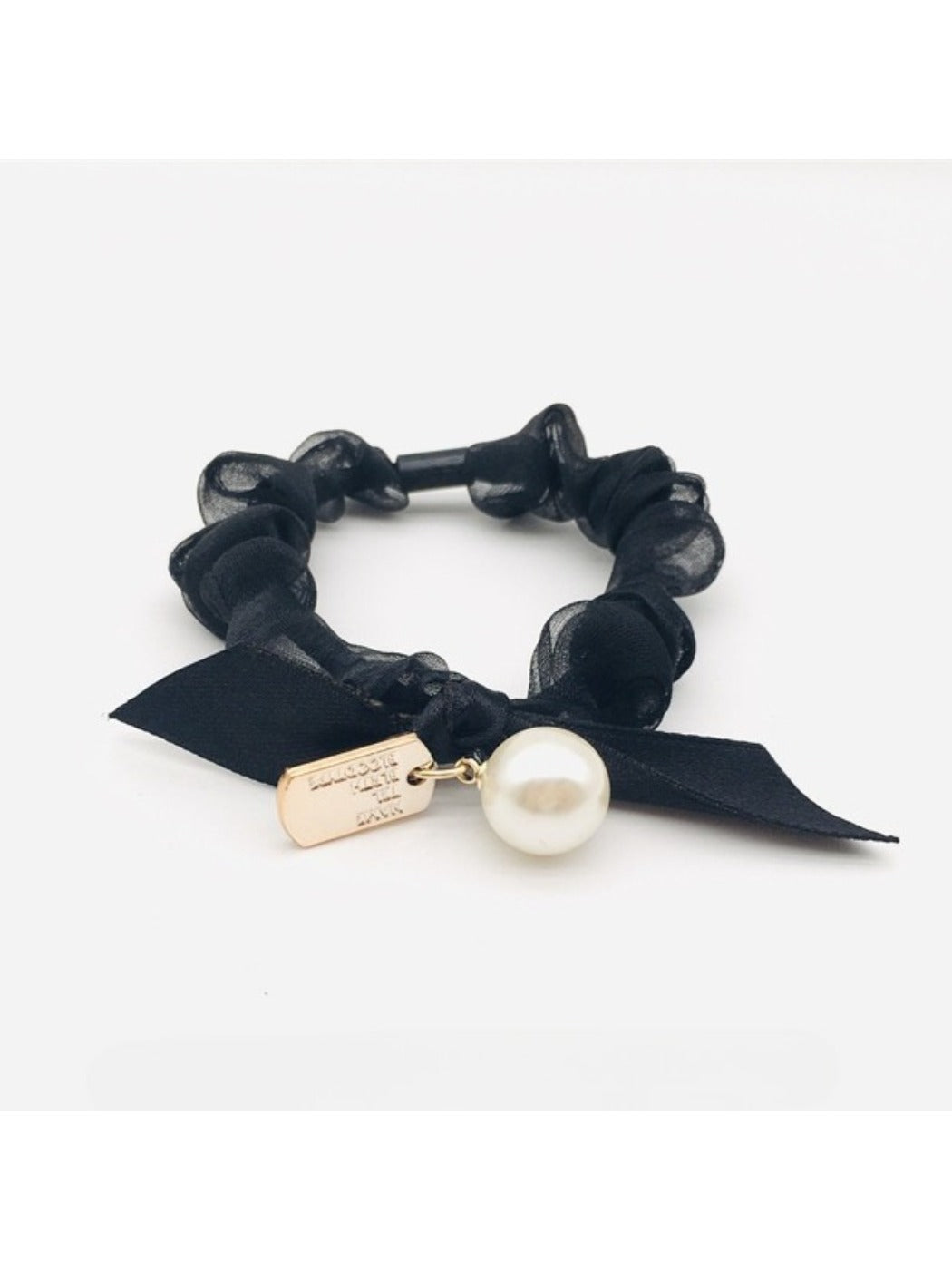 Gifty Sweet Bow Embellished Hair Tie worn on a model's wrist with soft lighting