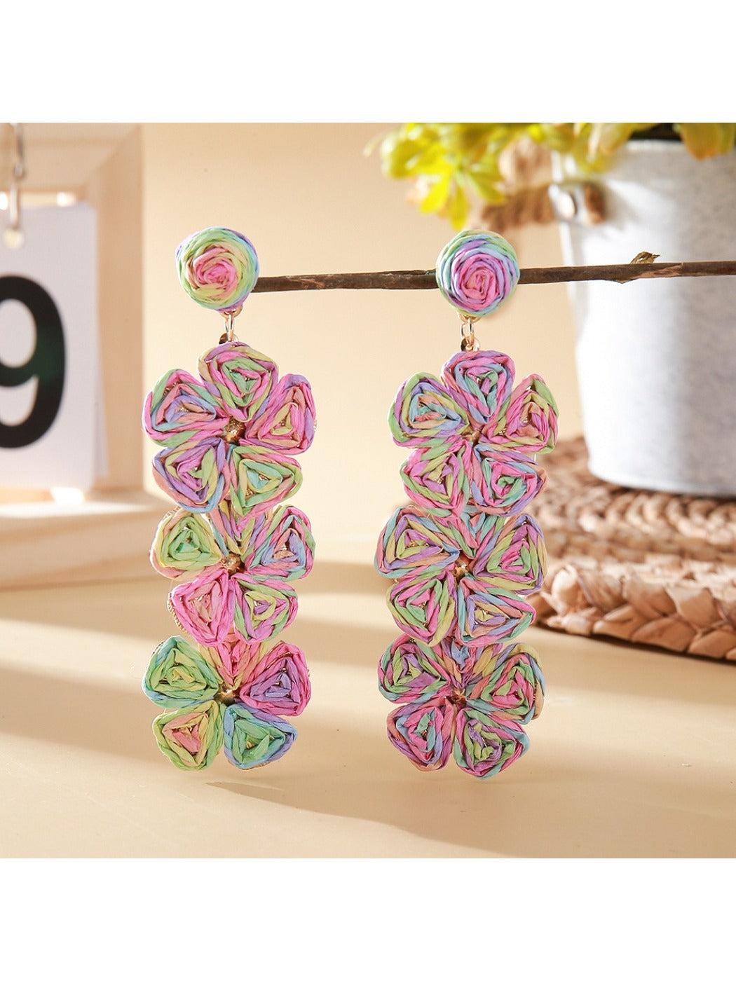 Earedge Bohemian drop earrings hanging on a decorative stand with natural light