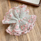 Side view of the pink ruffled scrunchie showing fabric texture