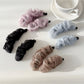 Beau tulle ruffle high ponytail claw clip displayed on a white background
