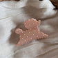Side view of Beau polka dot puppy hair clip displaying its curved shape and clasp