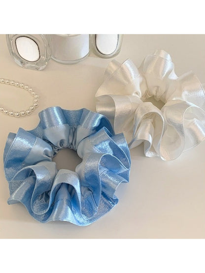 Gifty satin ruffle scrunchie in pastel purple laid flat to show ruffle detail