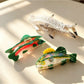 Beau fish shape claw clip held in hand to show size and grip