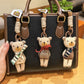 Fabric bear cub bag charm keychain hanging on a white background