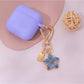 Keypus keychain with multiple floral charms in pink and white colors