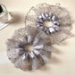 Gray mesh scrunchie with black polka dots on a white background