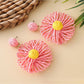 Raffia sunflower earrings shown alongside matching raffia accessories