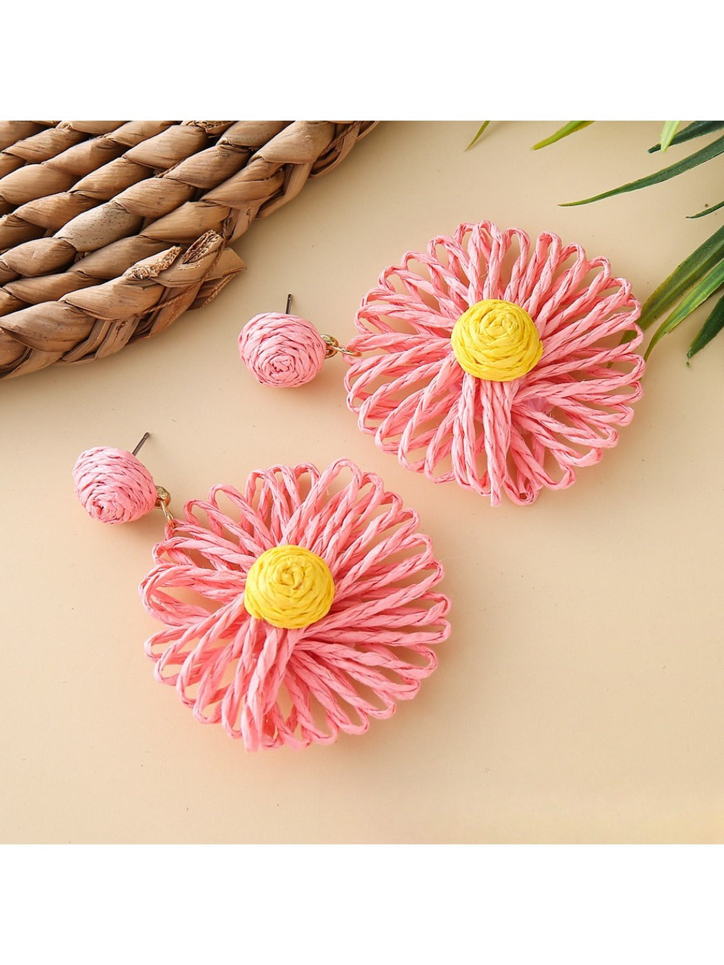 Raffia sunflower earrings shown alongside matching raffia accessories