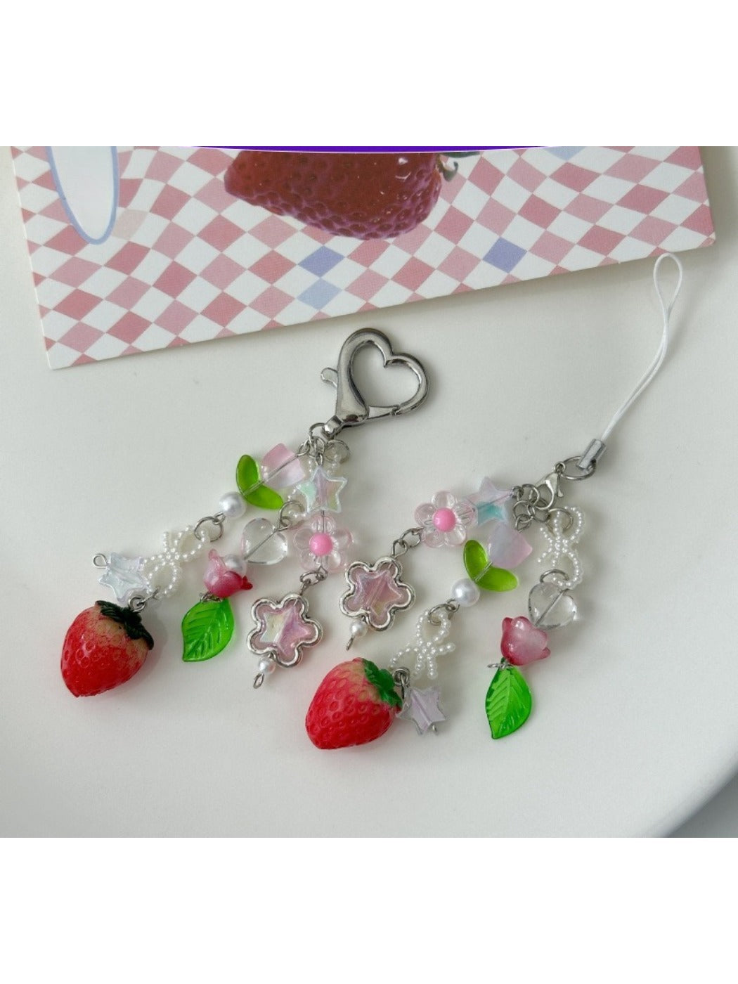 Sweet Tulip Strawberry keychain with red strawberry and green leaves on a silver key ring