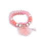 Lovra pompom pendant beaded bracelet coiled to show full design and colors
