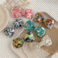 Beau - Marbled Acetate Bow Spring Hair Clip