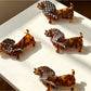 Top view of Beau cute cartoon dachshund claw clip with brown and black colors