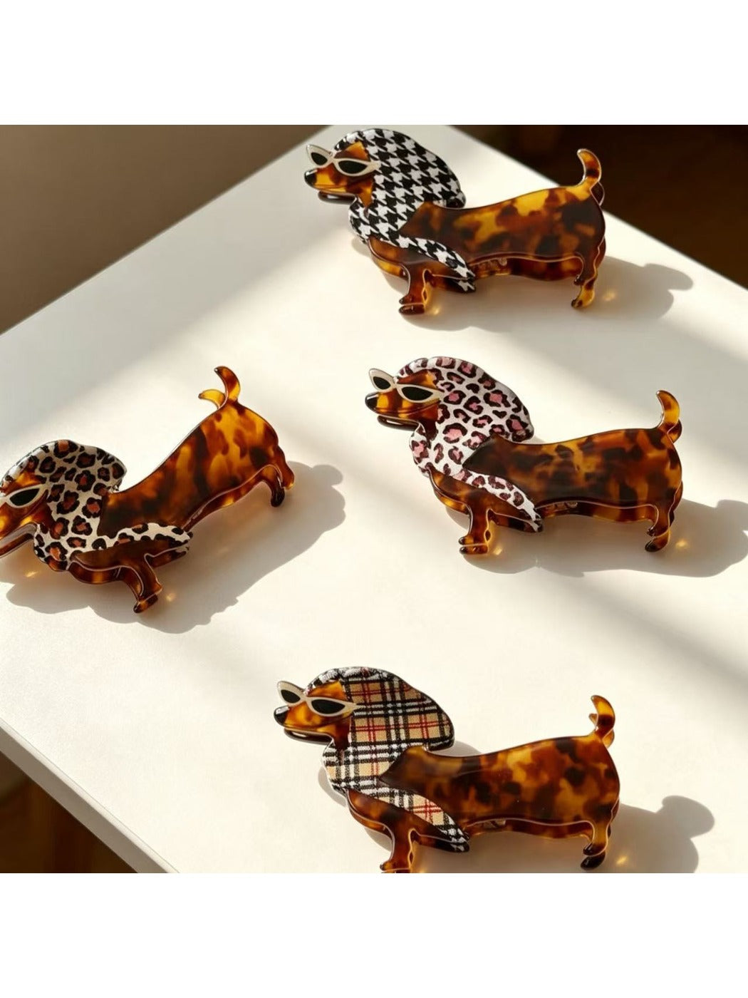 Top view of Beau cute cartoon dachshund claw clip with brown and black colors