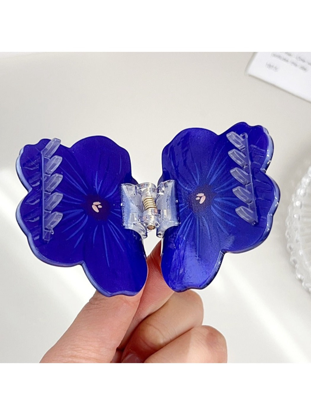 Side view of Beau flower shaped hair claw clip highlighting thickness and design