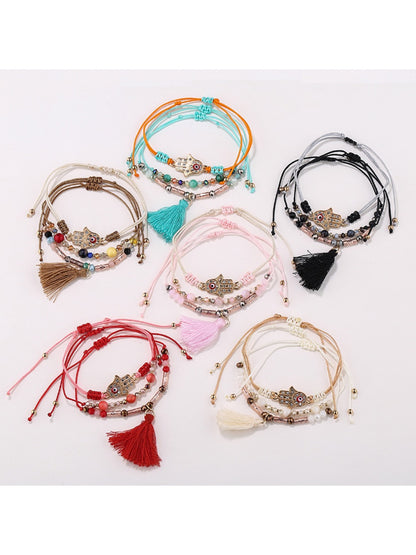 Lovra alloy charm tassel pendant bracelet on white background