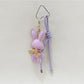 Cartoon bunny keychain with smiling expression on a keyring