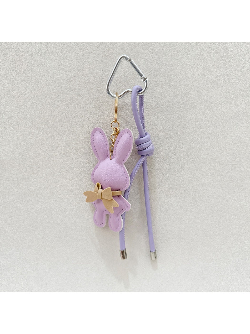 Cartoon bunny keychain with smiling expression on a keyring
