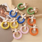 Close-up of Earedge round floral pendant earrings with intricate flower design
