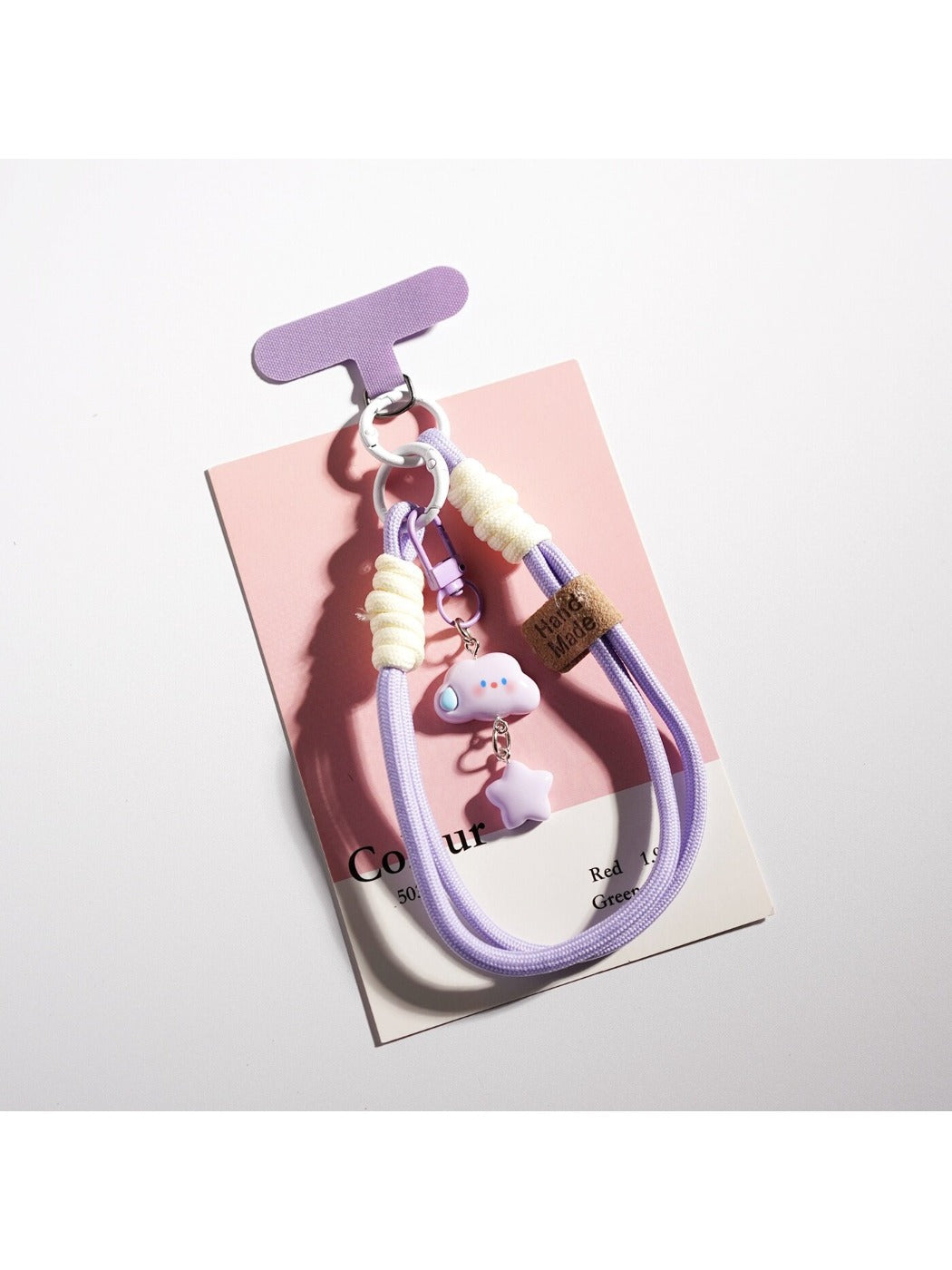 Cloud and star keychain attached to a set of keys on a wooden surface