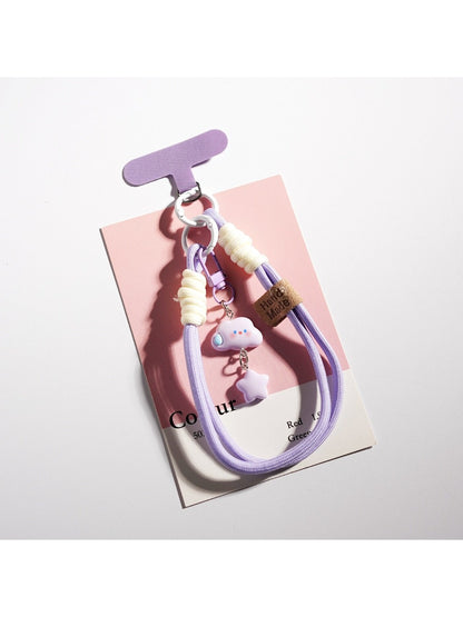 Cloud and star keychain attached to a set of keys on a wooden surface