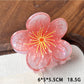 Top view of Beau acetate floral claw clip emphasizing layered petals and color gradient