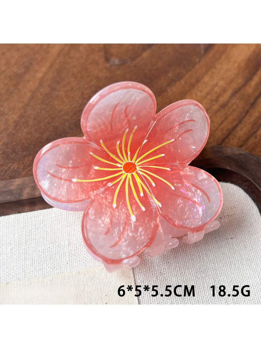 Top view of Beau acetate floral claw clip emphasizing layered petals and color gradient