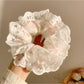 Gifty scrunchie displayed with matching accessories emphasizing sweet and charming style