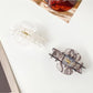 Beau Romantic Lace Vibe hair clip held in hand highlighting size and texture