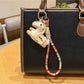 Side view of Keypus pony charm keychain showing detailed mane and tail design