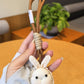 Back view of the little bunny shaped bag charm keychain in pastel pink