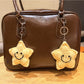 Keypus star shaped keychain attached to a handbag zipper pull