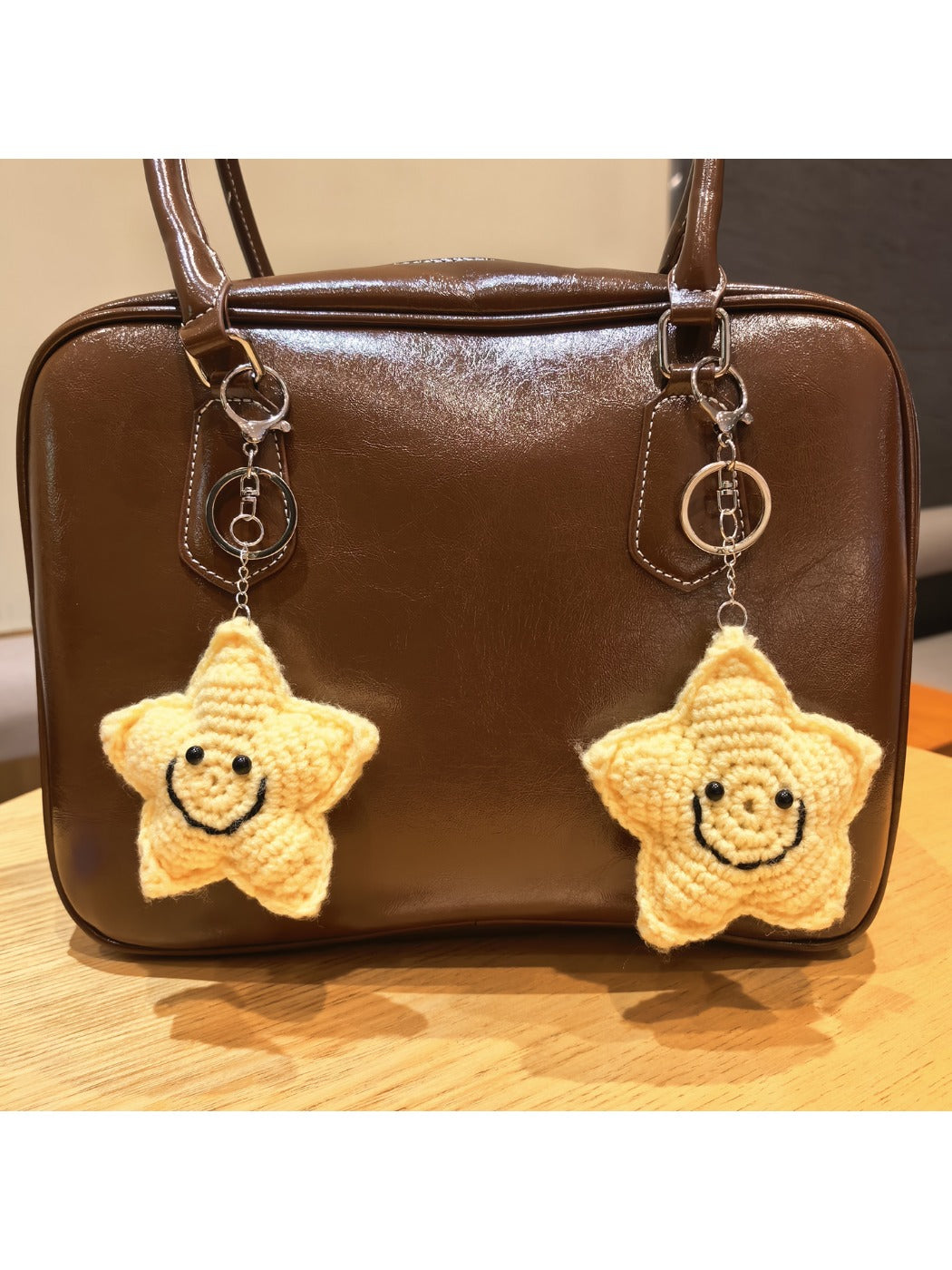 Keypus star shaped keychain attached to a handbag zipper pull