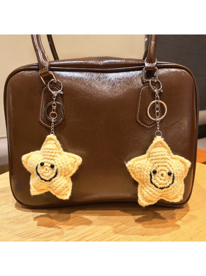 Keypus star shaped keychain attached to a handbag zipper pull