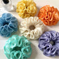 Close-up of Gifty minimalist solid color ruffle scrunchie in soft fabric