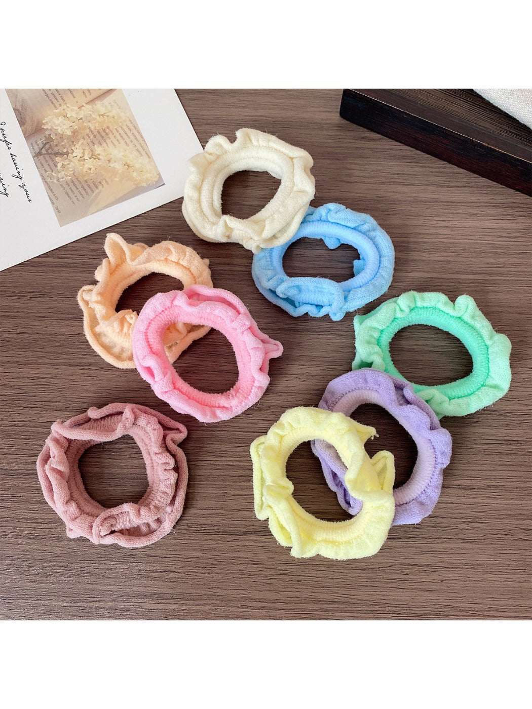 Set of colorful ruffled hair ties displayed on a wooden surface