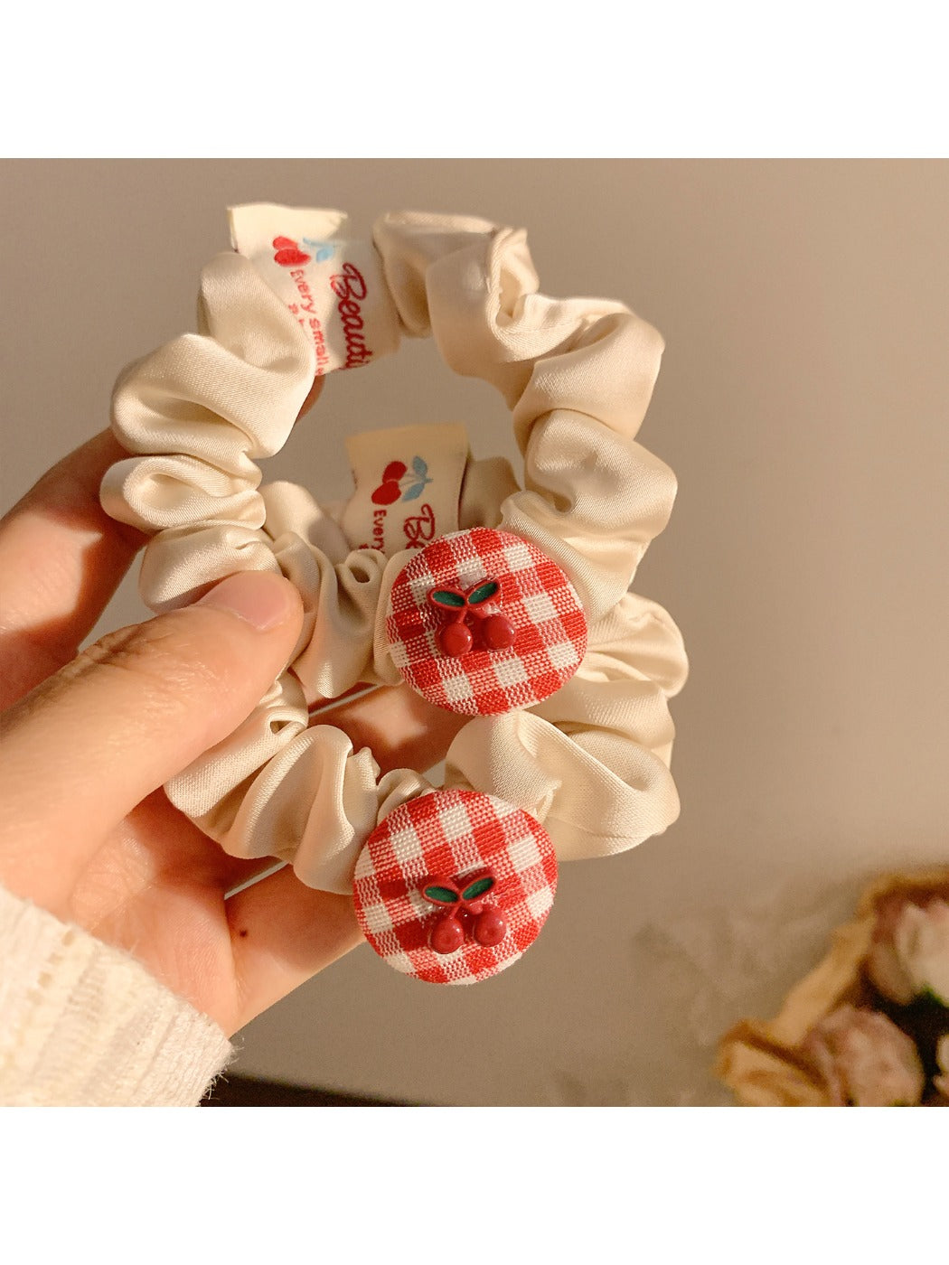 Gifty Sweet Plaid Cherry Hair Tie styled on a ponytail with visible cherry charm